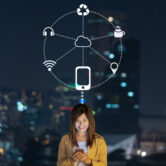 Asian businesswoman using smart mobile phone with smile action for operate various icon