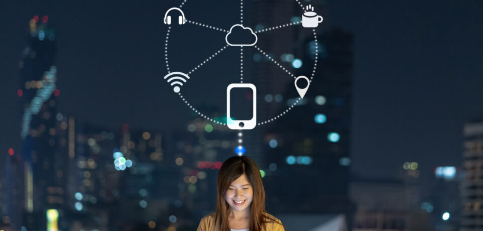 Asian businesswoman using smart mobile phone with smile action for operate various icon